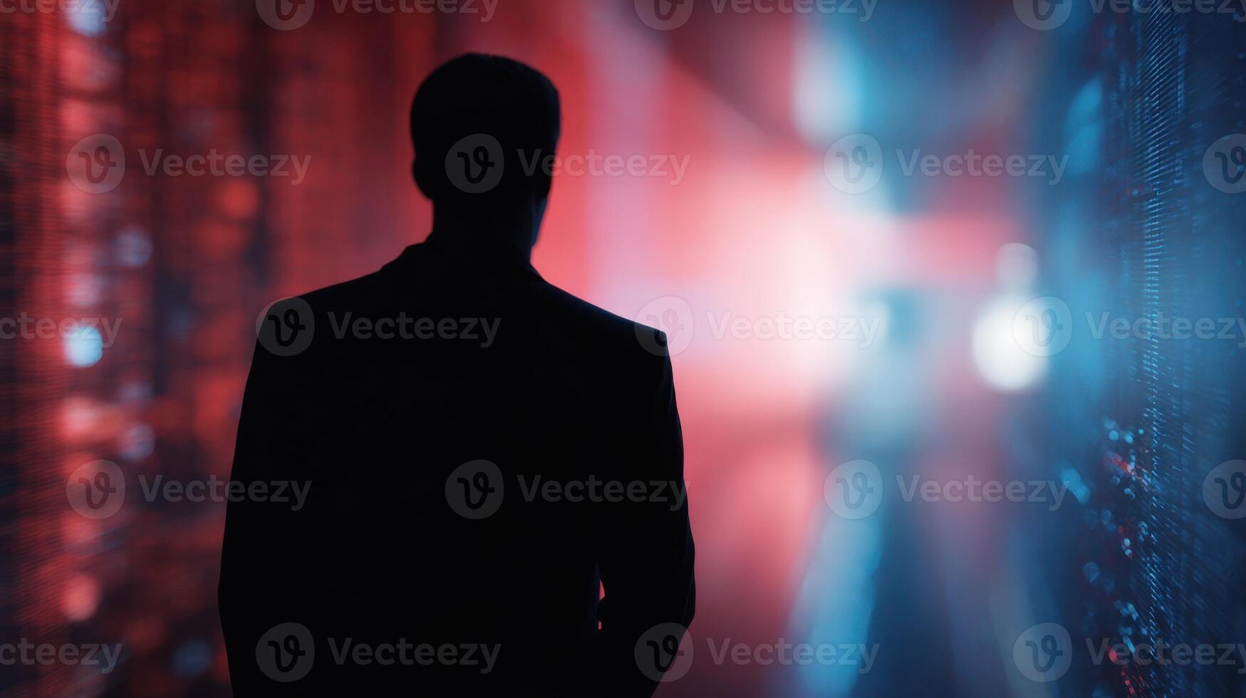 The silhouette of a man in a futuristic data corridor illuminated by colorful lights. photo