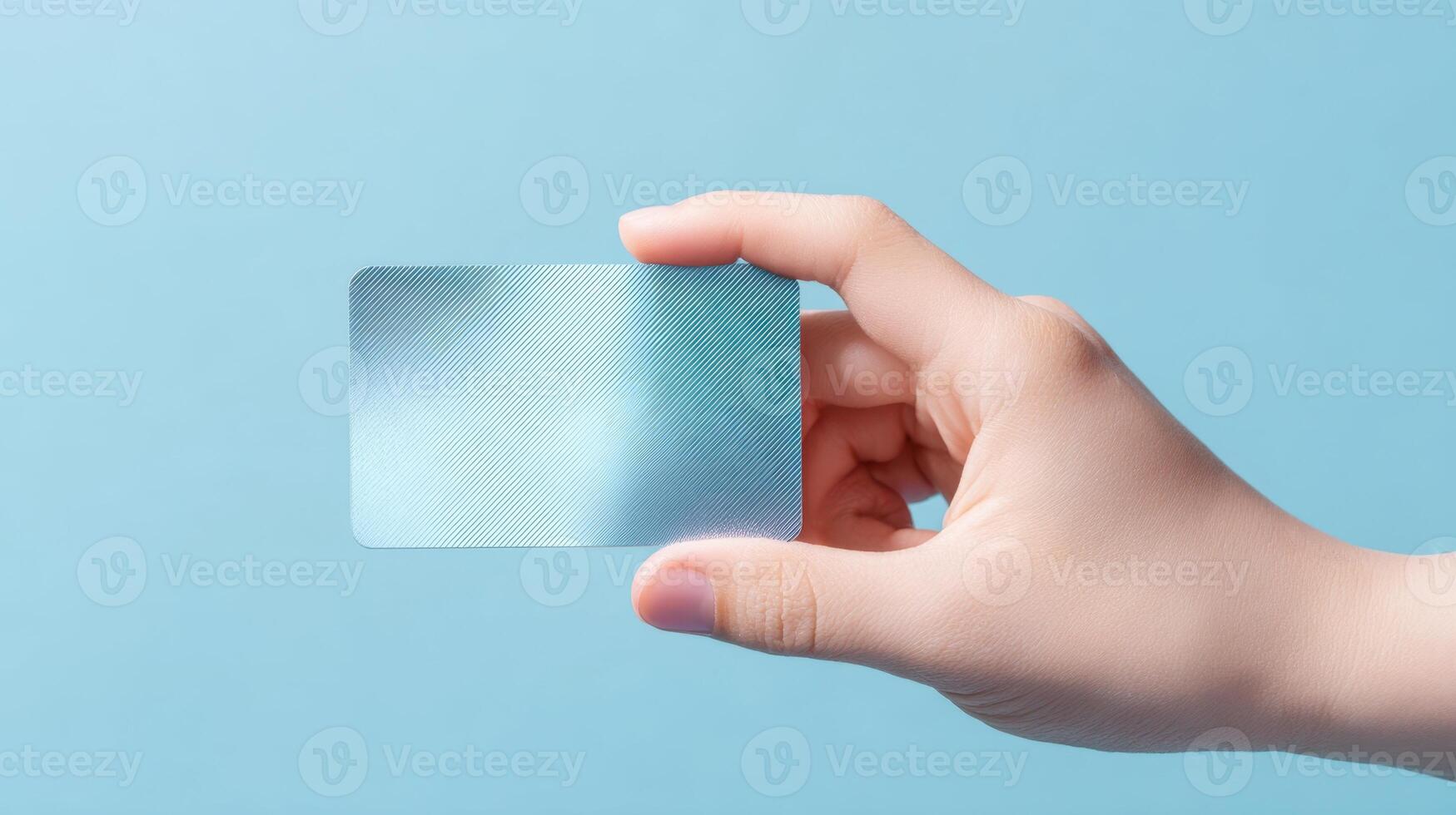 The Clear Card Held in a Hand Against a Minimalistic Blue Background. photo