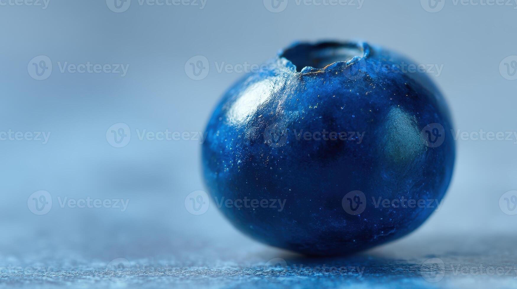 The close-up of a fresh blueberry showcasing its vibrant color and texture. photo