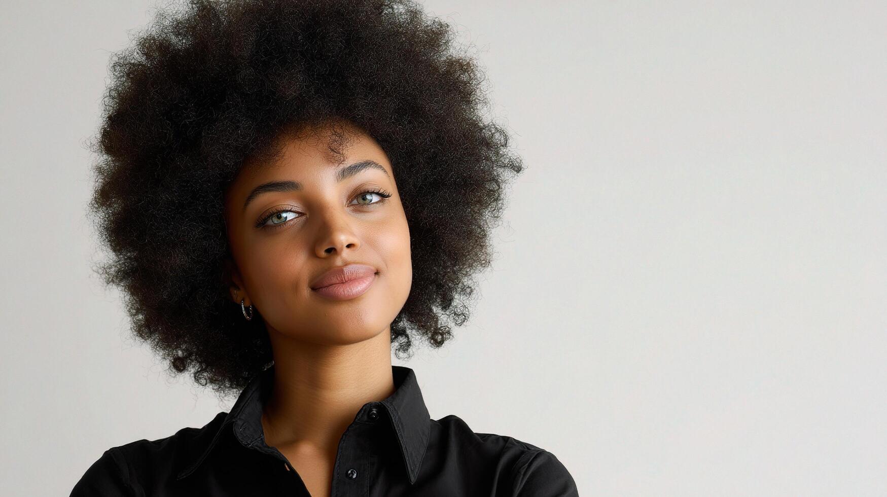 A woman with an afro hair style and a black shirt photo