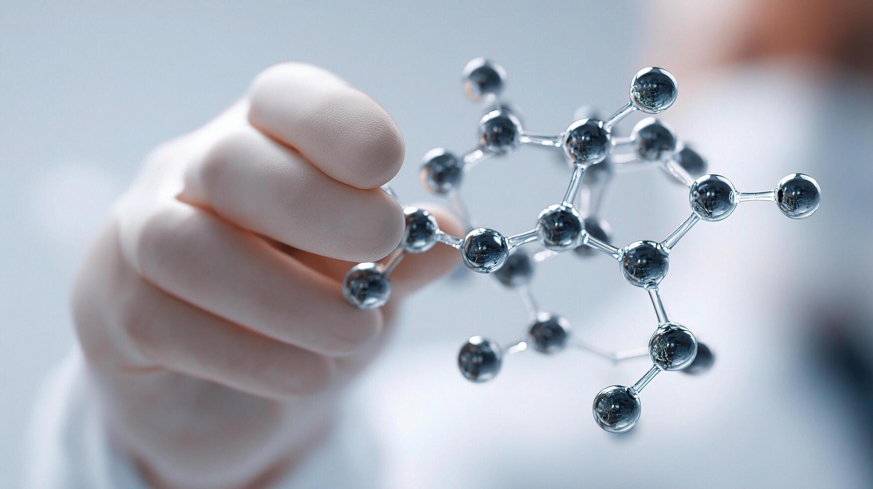 A person holding a molecule model in their hand photo