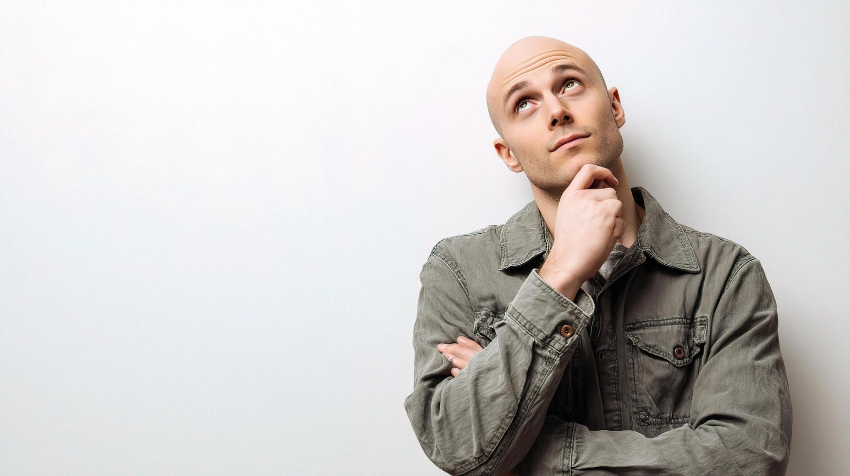 A bald man with a thought on his mind photo