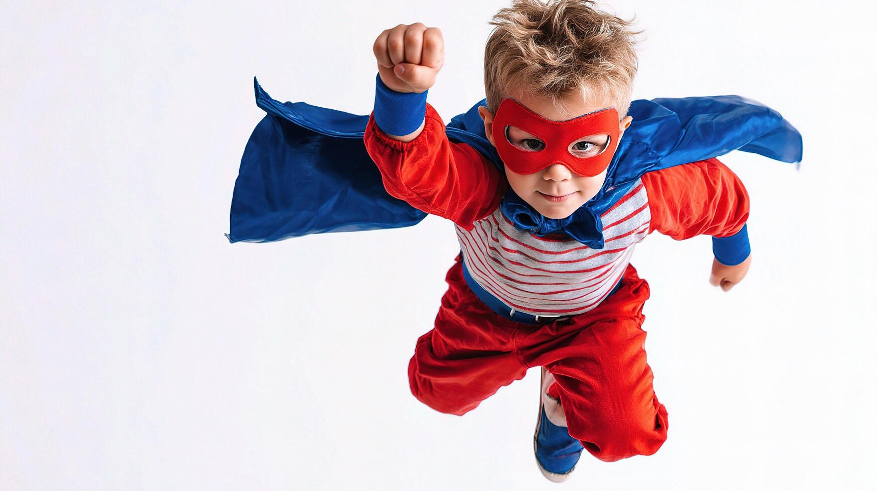 A young boy in a superhero costume flying through the air photo