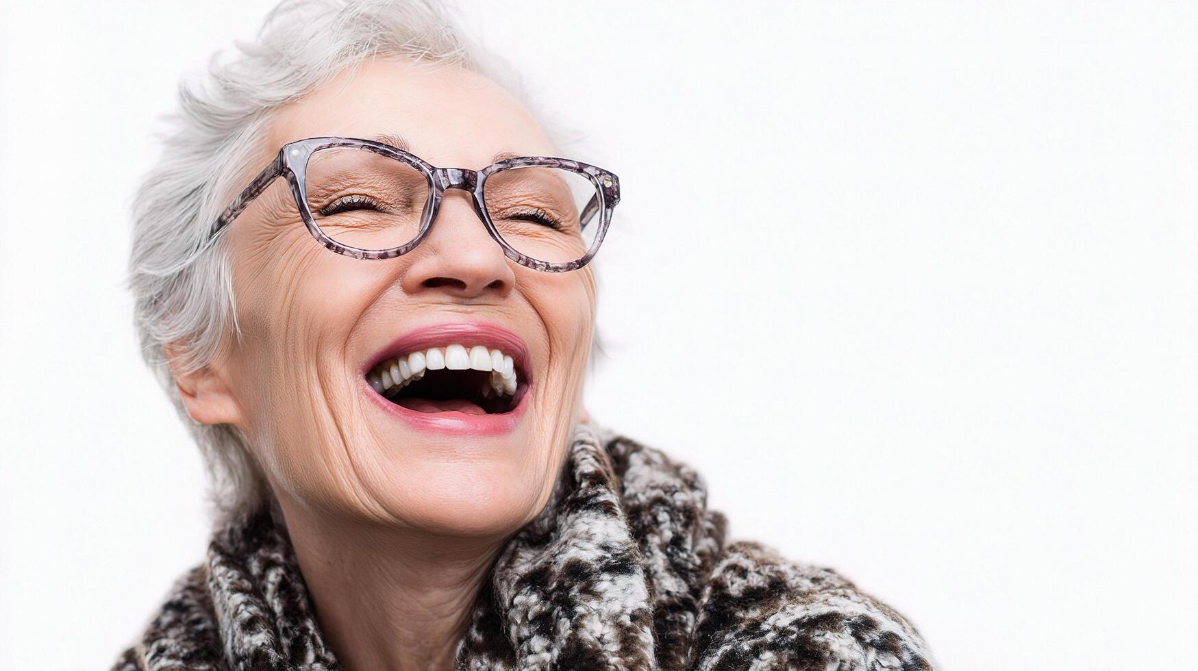 A woman with glasses and a scarf laughing photo