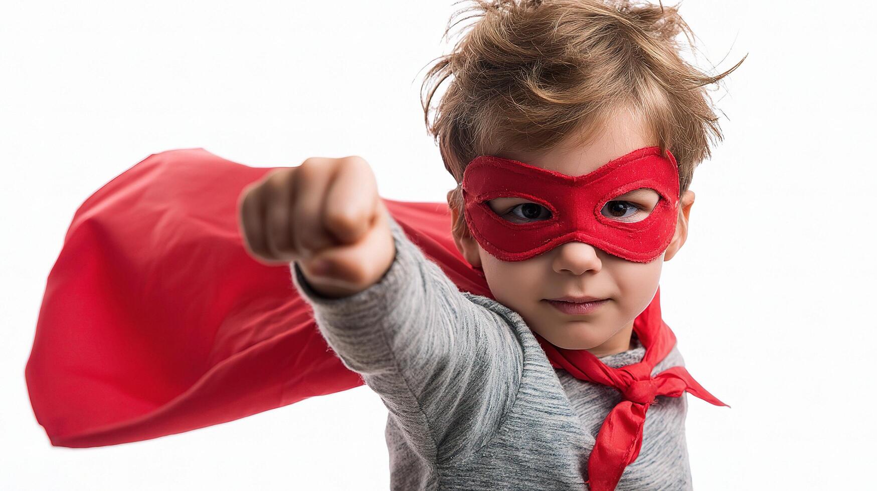A young boy in a red cape and mask photo