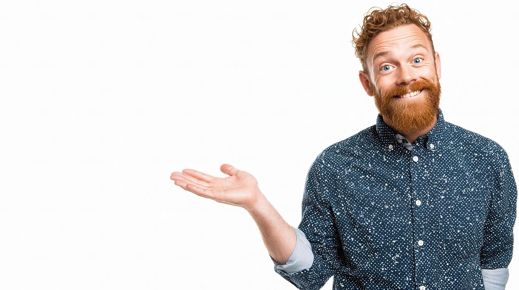 A man with a beard and a blue shirt is holding something photo