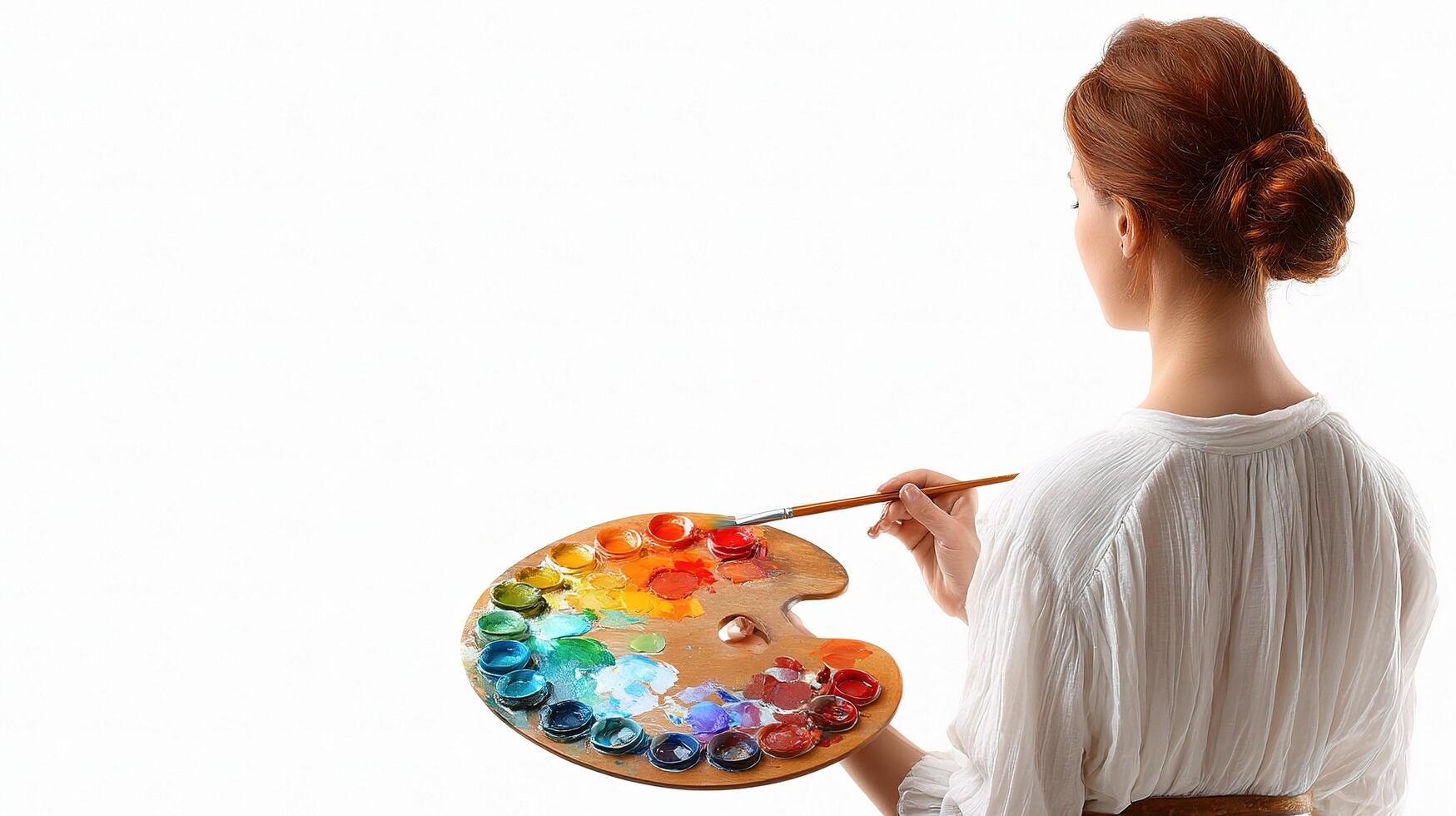 A woman holding a palette and paint brush photo