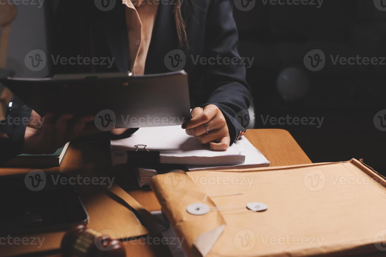 A woman in a suit is holding a clipboard photo