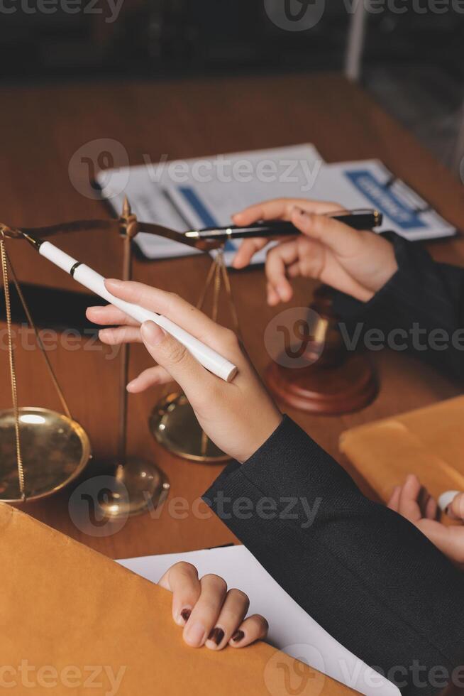 Business people holding scales and papers photo