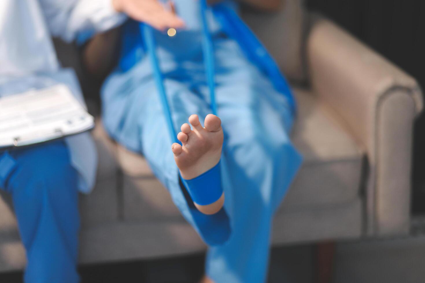 A doctor is holding a foot with a bandage photo