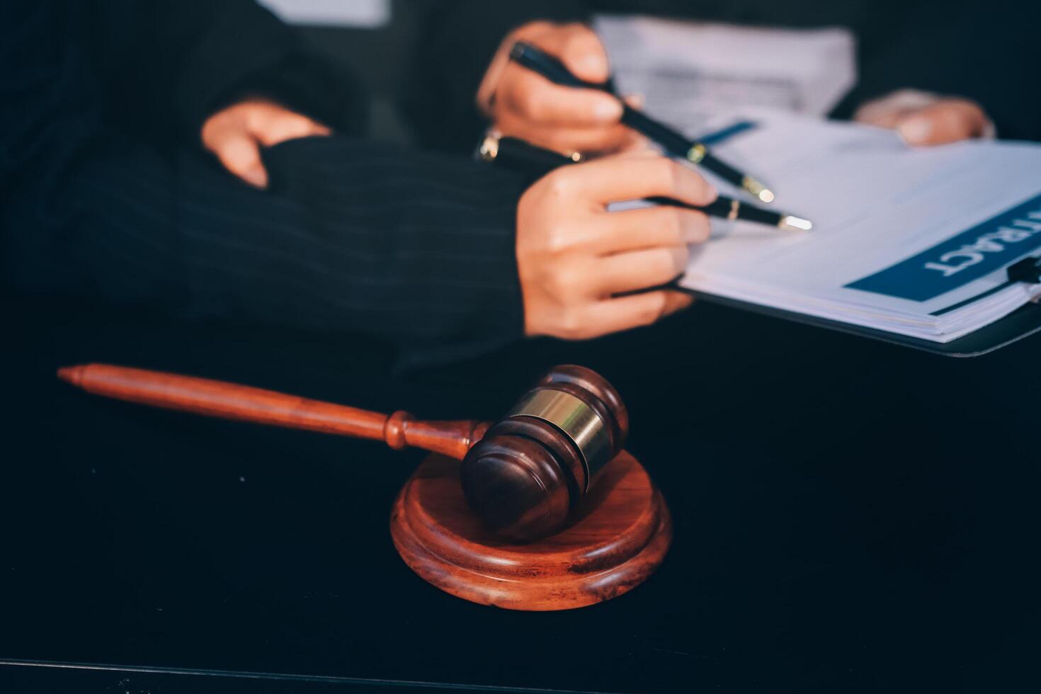 Lawyer and judge signing documents on a desk photo
