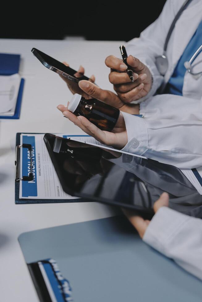 A group of doctors using their phones and tablets photo
