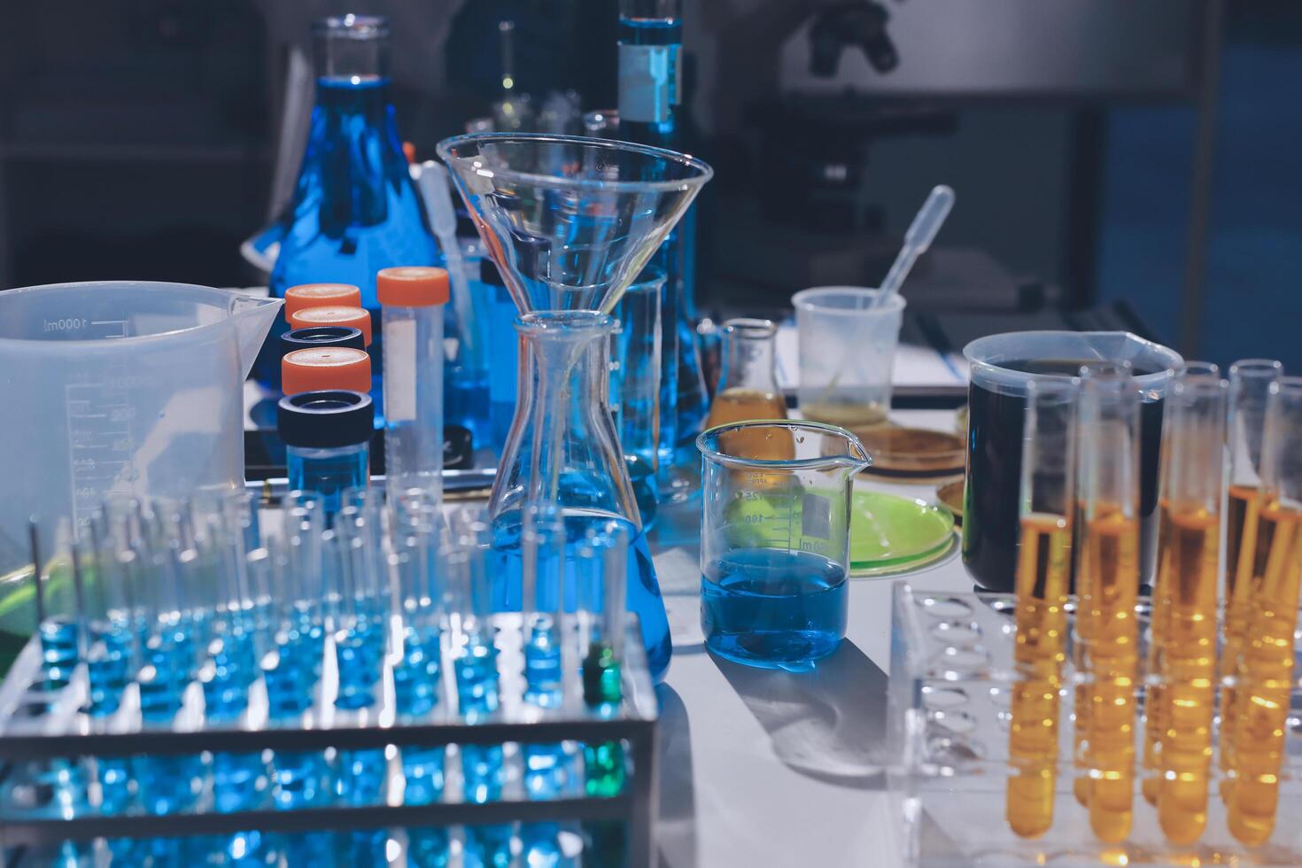 A laboratory table with many different colored liquids photo