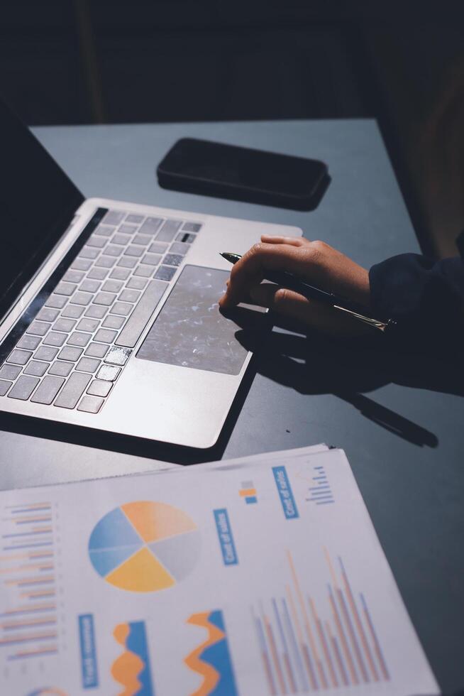 A person is using a laptop with a graph on it photo