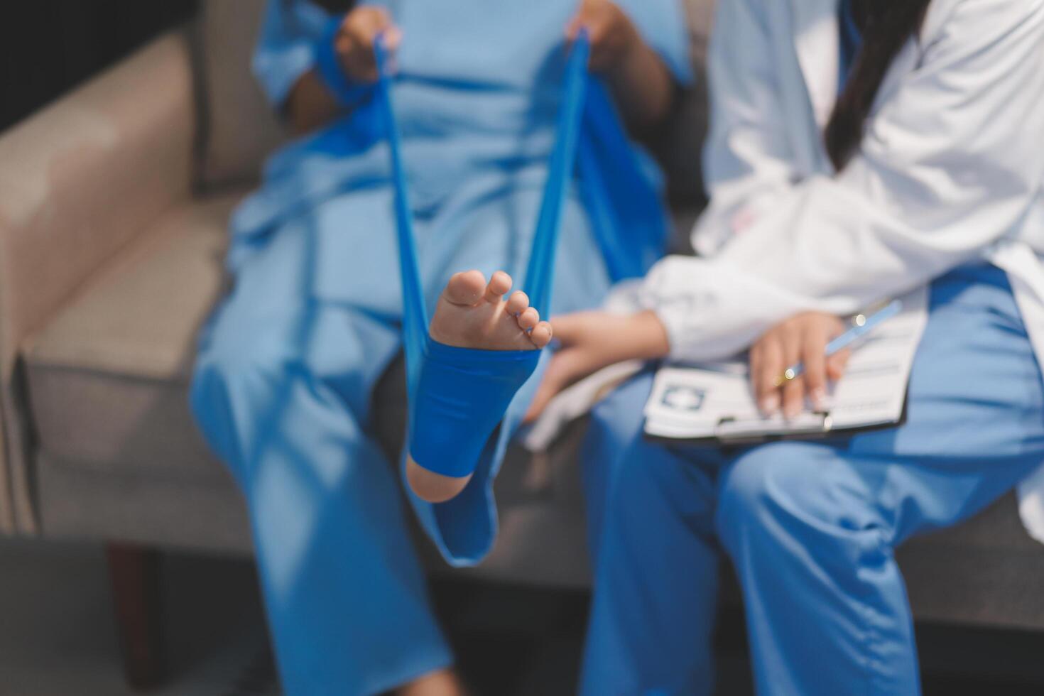 A doctor is holding a foot with a bandage on it photo