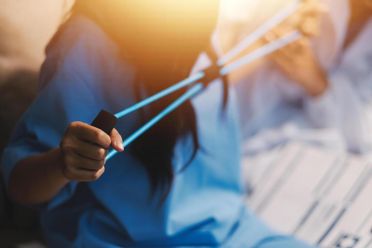 A woman in blue holding a pair of scissors photo