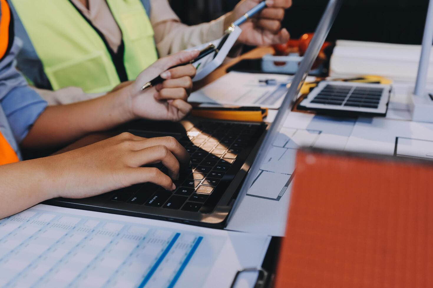 A person working on a laptop computer with a construction worker photo