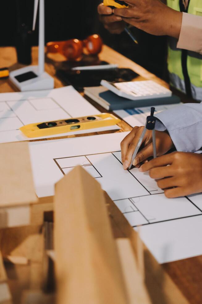 A man is working on a blueprint with a pencil photo