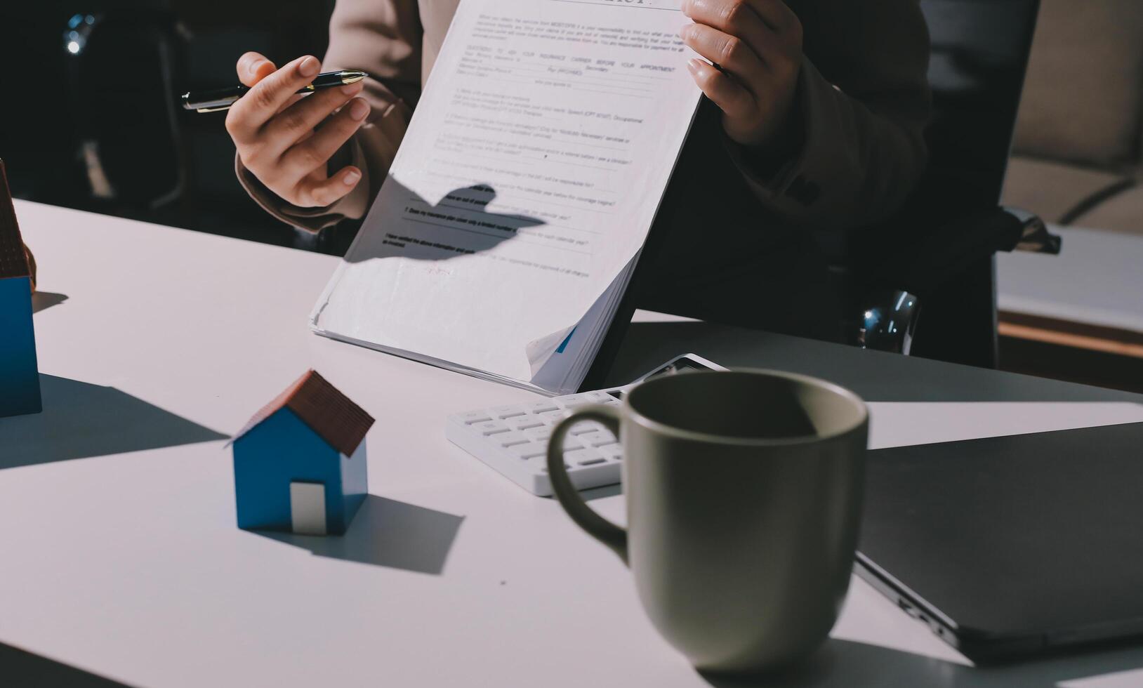 A person is holding a piece of paper with a contract on it photo