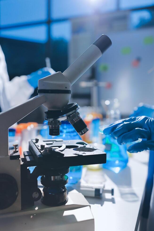 A group of people in lab coats are looking at something photo
