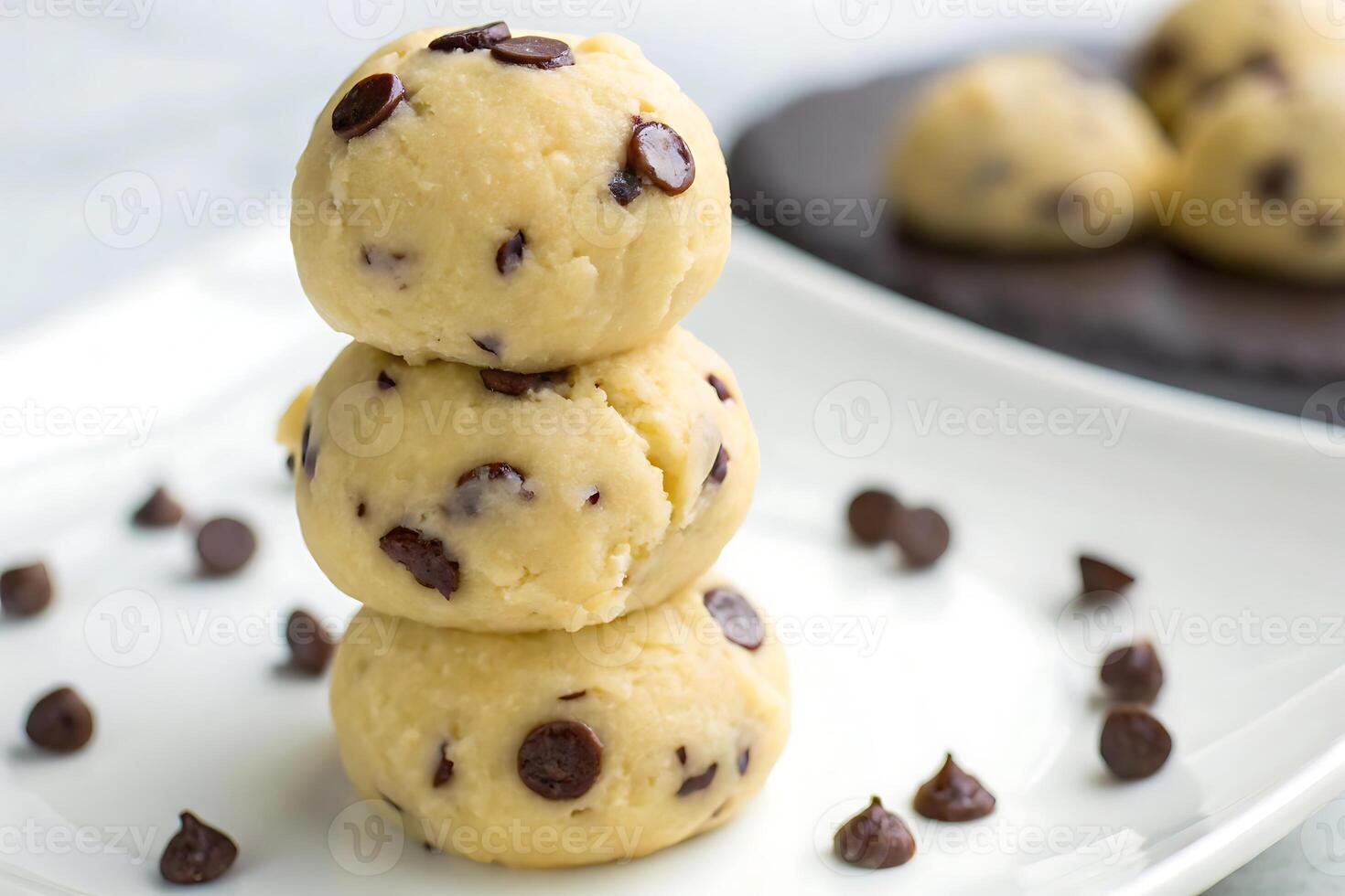 three chocolate chip cookie dough balls on a plate photo