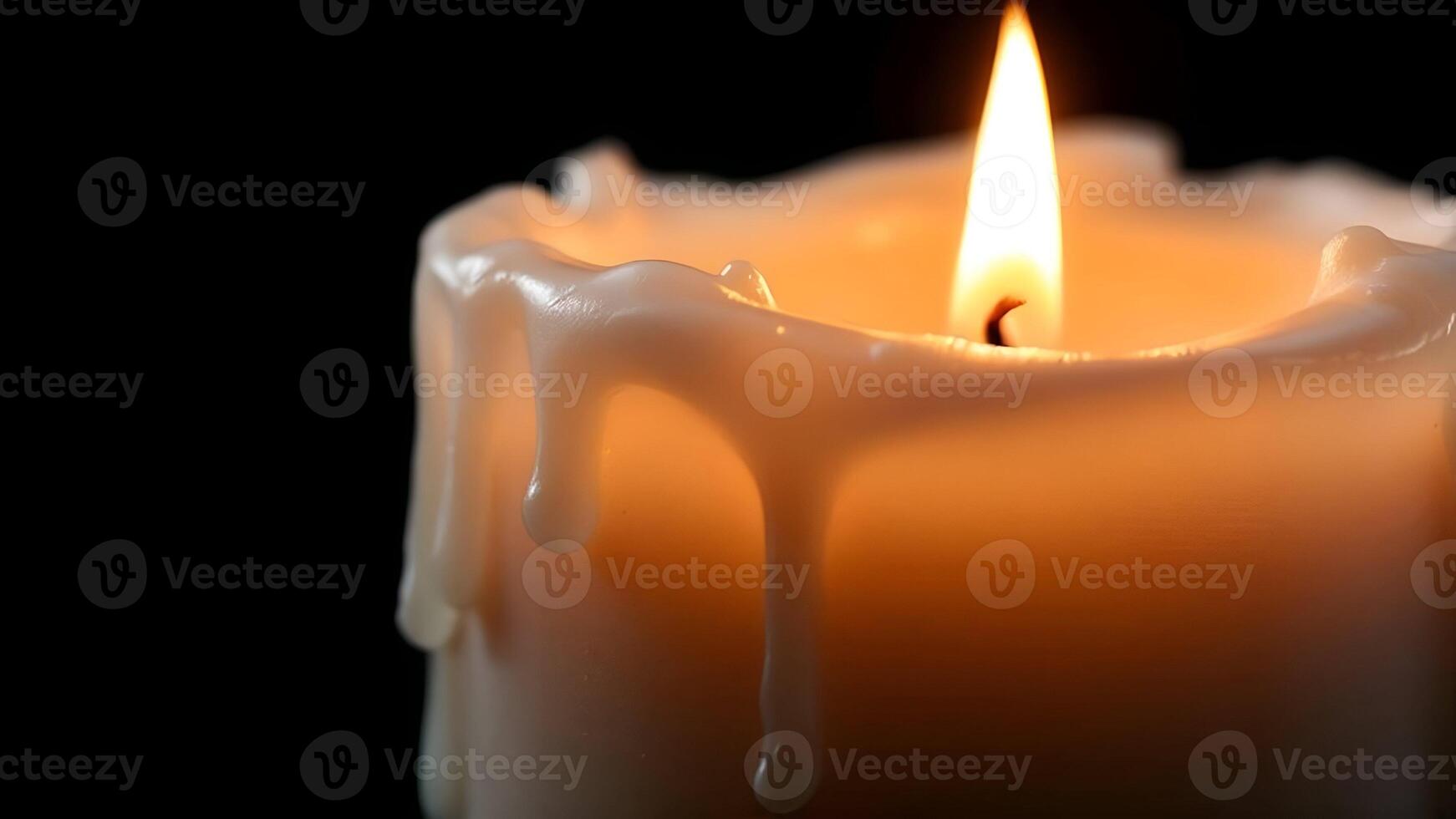 A close-up shot of a lit white candle with melted wax dripping down its sides, against a dark background, creating a peaceful ambiance photo