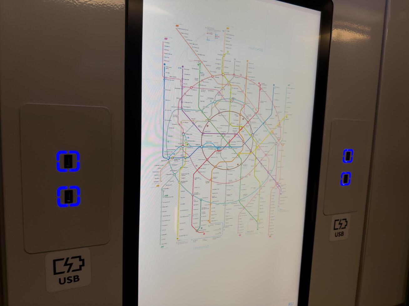 Moscow, Russia, April 25, 2025 Digital metro map and USB charging ports inside modern subway train, showing technological upgrades in Moscow Metro for commuter convenience and comfort photo