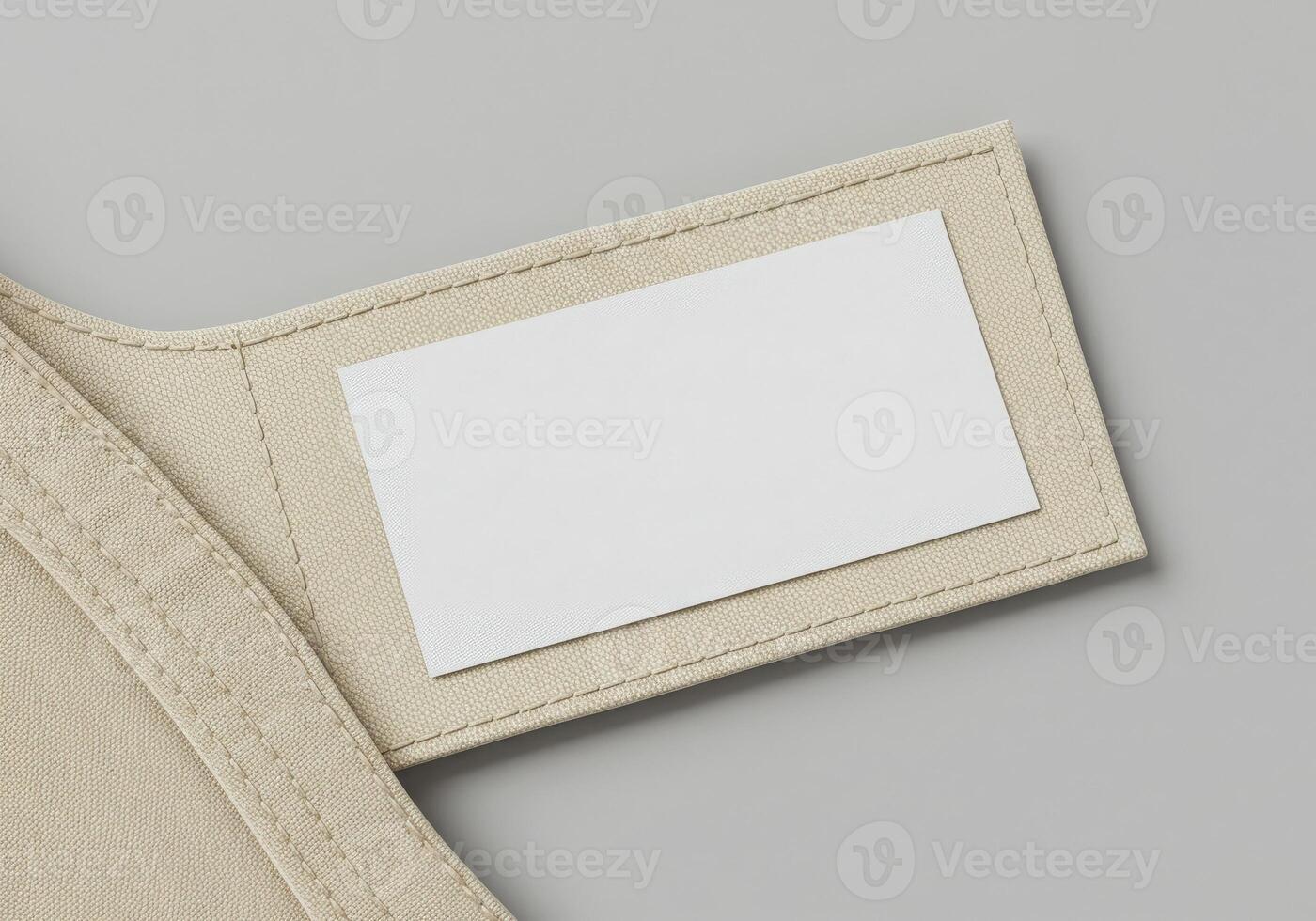 A white card is attached to the back of a beige wallet photo
