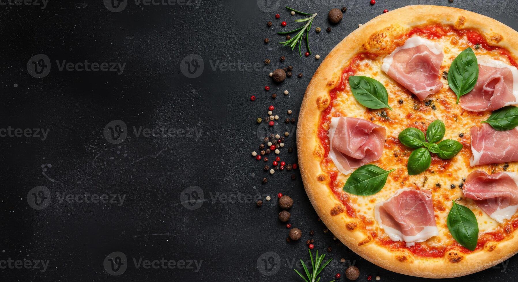 Pizza with ham, cheese and herbs on a black background photo