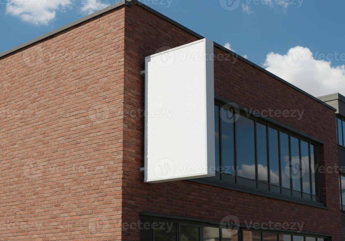 A white billboard is mounted on a brick building mockup photo