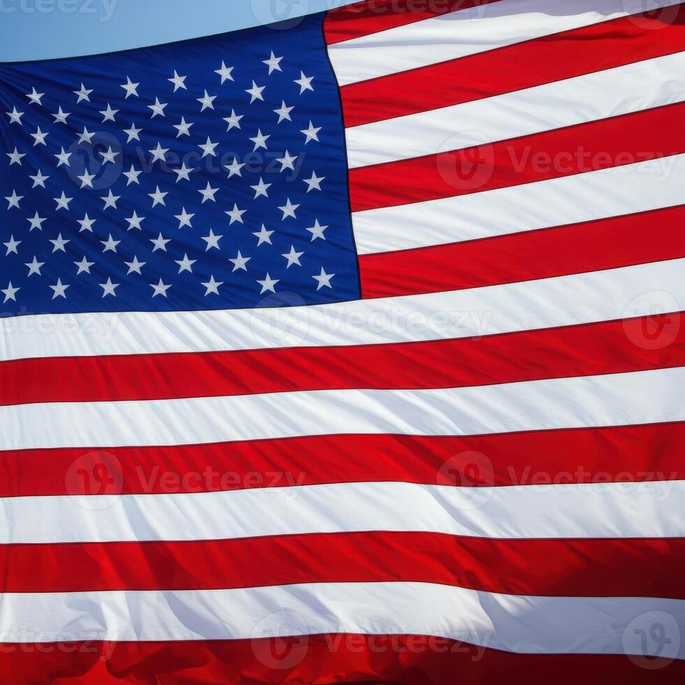 A close up of an american flag with a blue sky photo