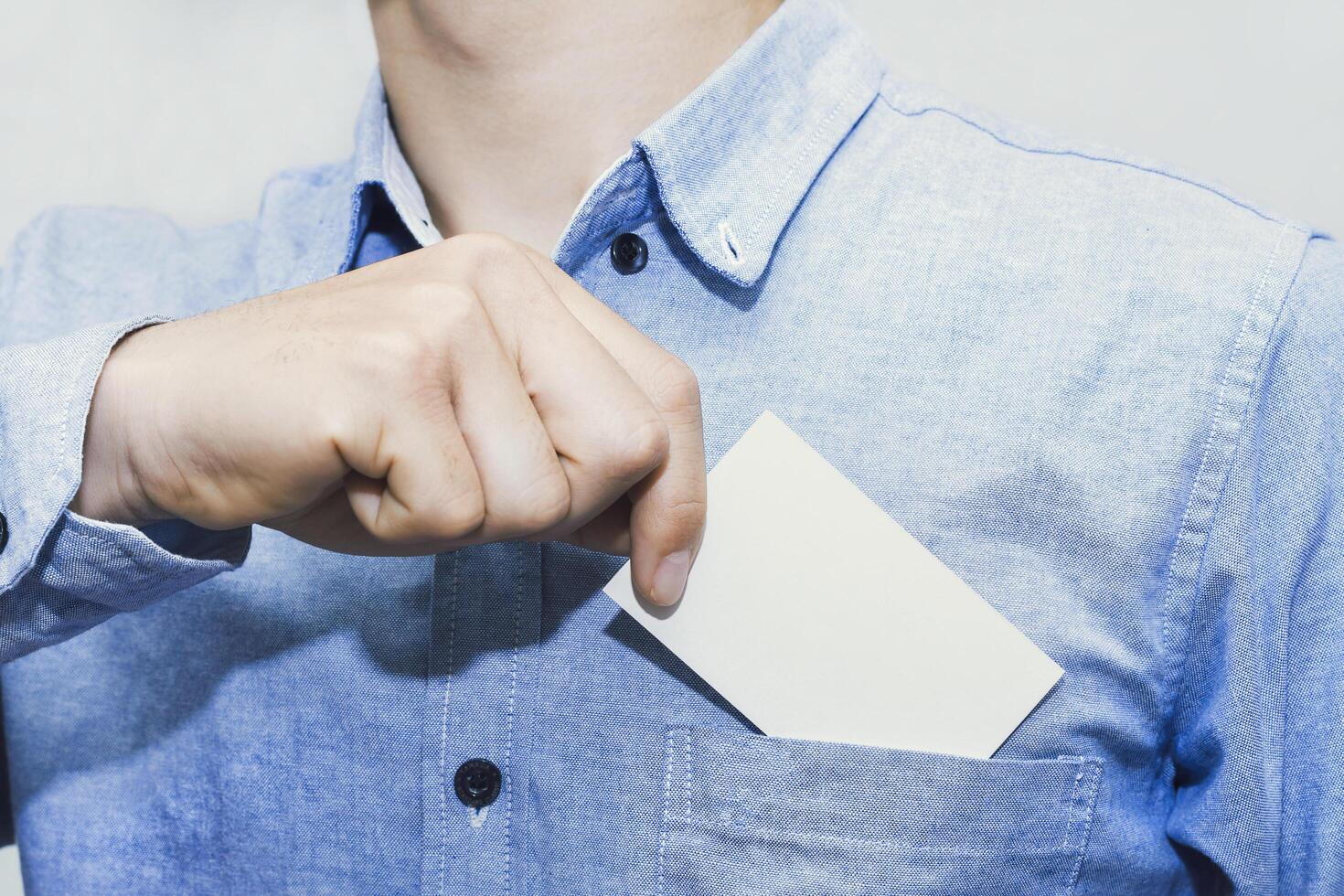 Minimal business card template held by professional man. Great for communication, branding, corporate contact, identity mockup, marketing, business info, message, and visual presentation. photo