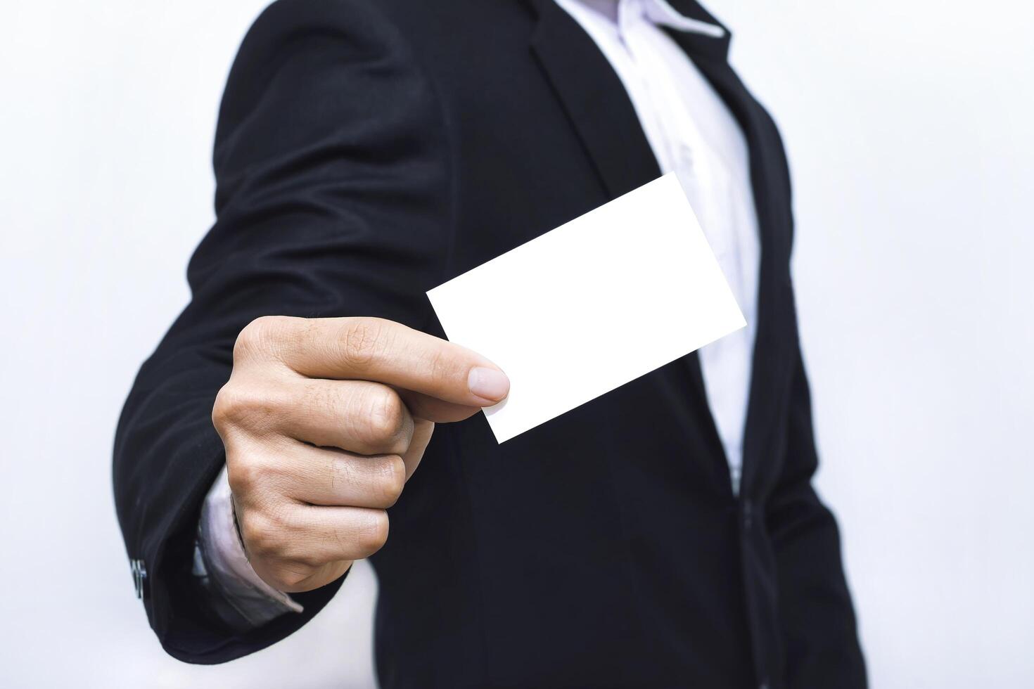 Businessman presenting empty business card mockup template for custom design identity. photo