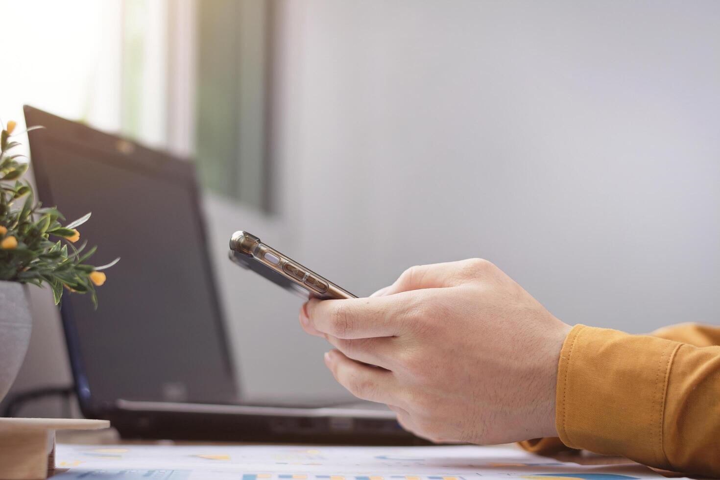 Business male casual wear pointing on smartphone screen, chatting in social networks, meeting website, searching internet, sending sms, using text messenger or online banking. Work at home concept photo