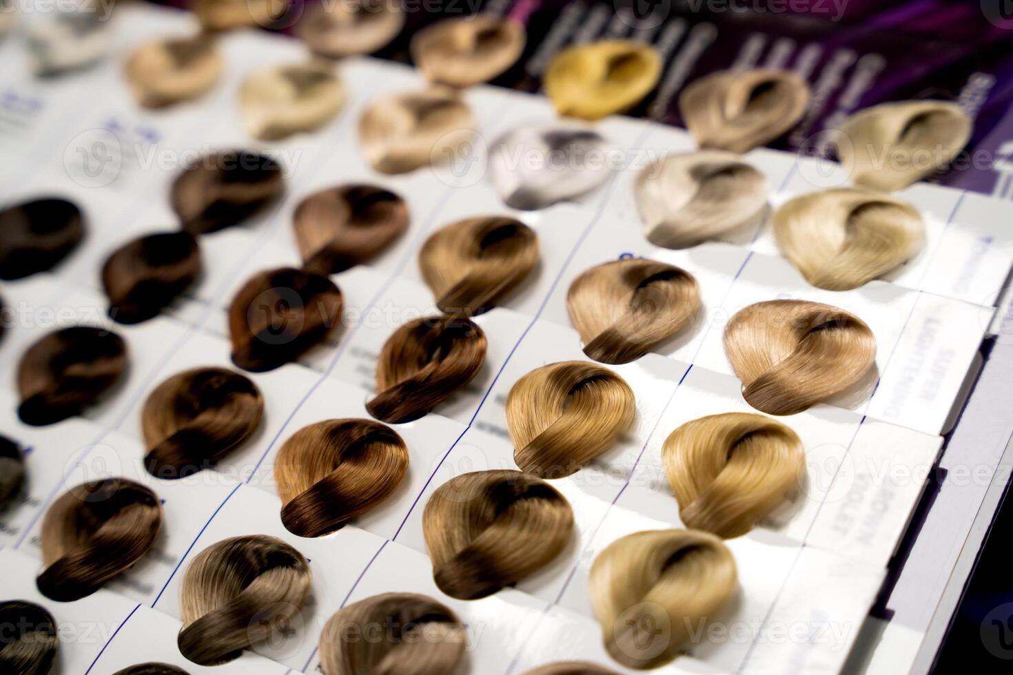 A palette of paint samples in a hair salon. Dyeing, changing hair colour, safe haircare concept. Close-up. Selective focus. photo