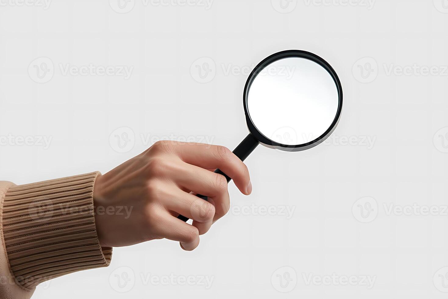 Close-up of hand holding magnifying glass for investigation or search concept photo