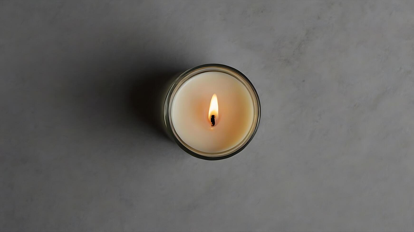 Top-Down View of Lit Candle in Glass Jar on Gray Surface, Serenity photo