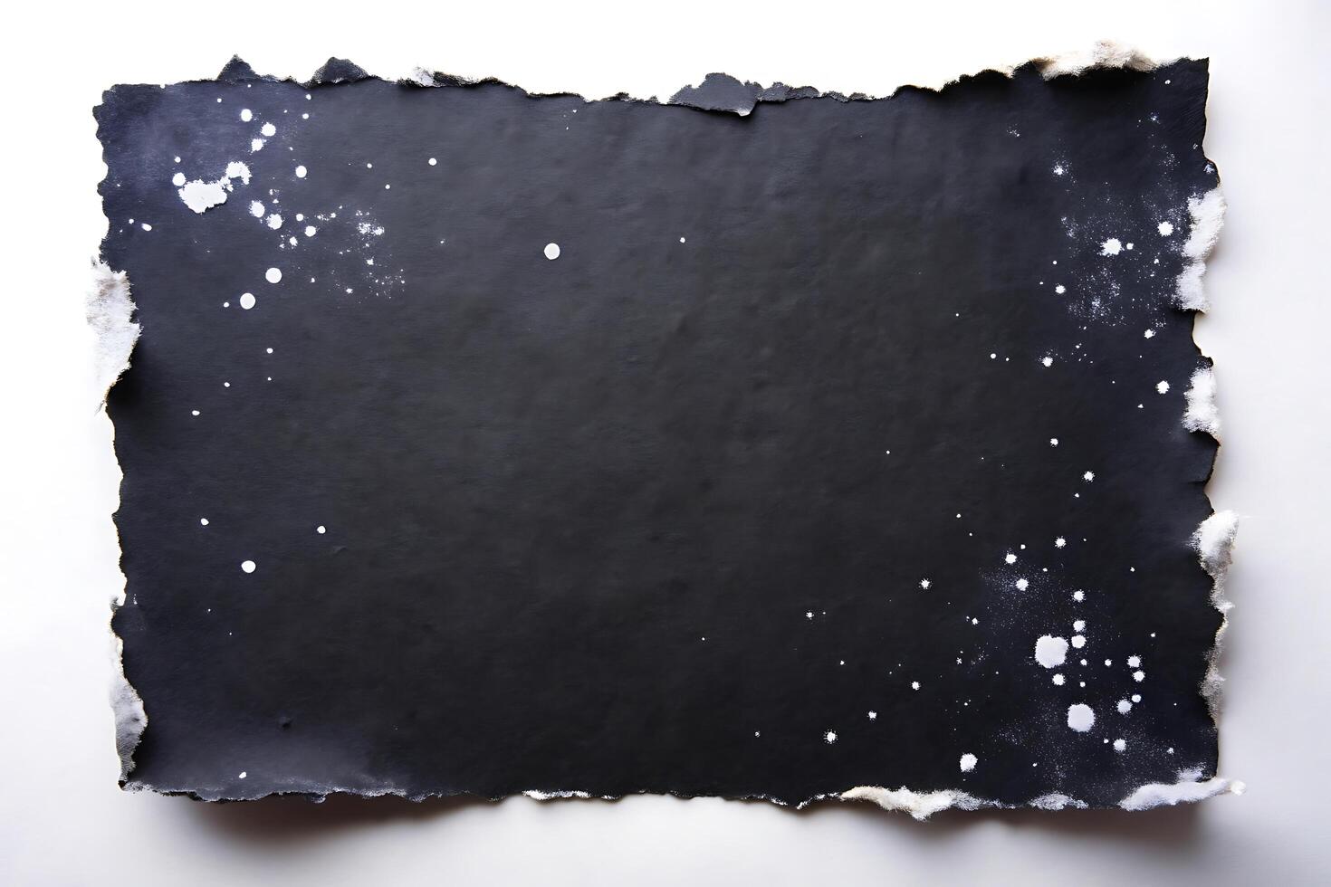Abstract Black Paper with Torn Edges and White Splatters for Creative Backgrounds photo