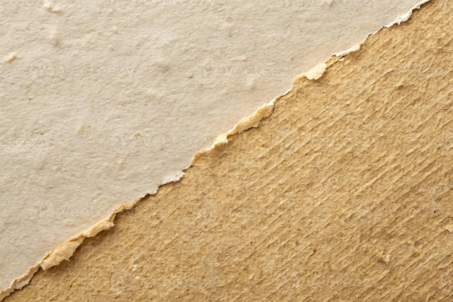 A Close-Up Shot of Two Different Textures of Torn Paper with an Edge Separating Them photo