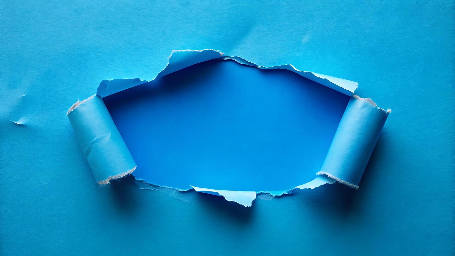 Torn Blue Paper with Rolled Edges Revealing a Deep Blue Hole photo