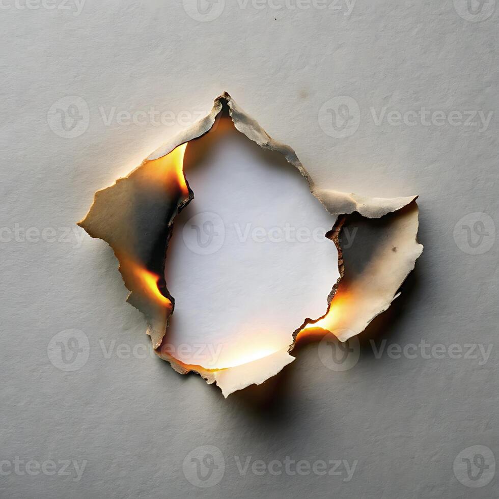 Burnt Paper Hole with Glowing Edges Reveals Clean White Space photo