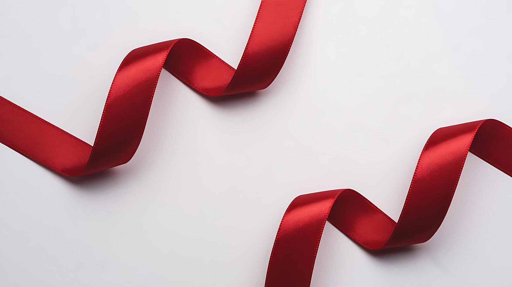 Elegant crimson ribbon gracefully curving across a pristine white surface photo