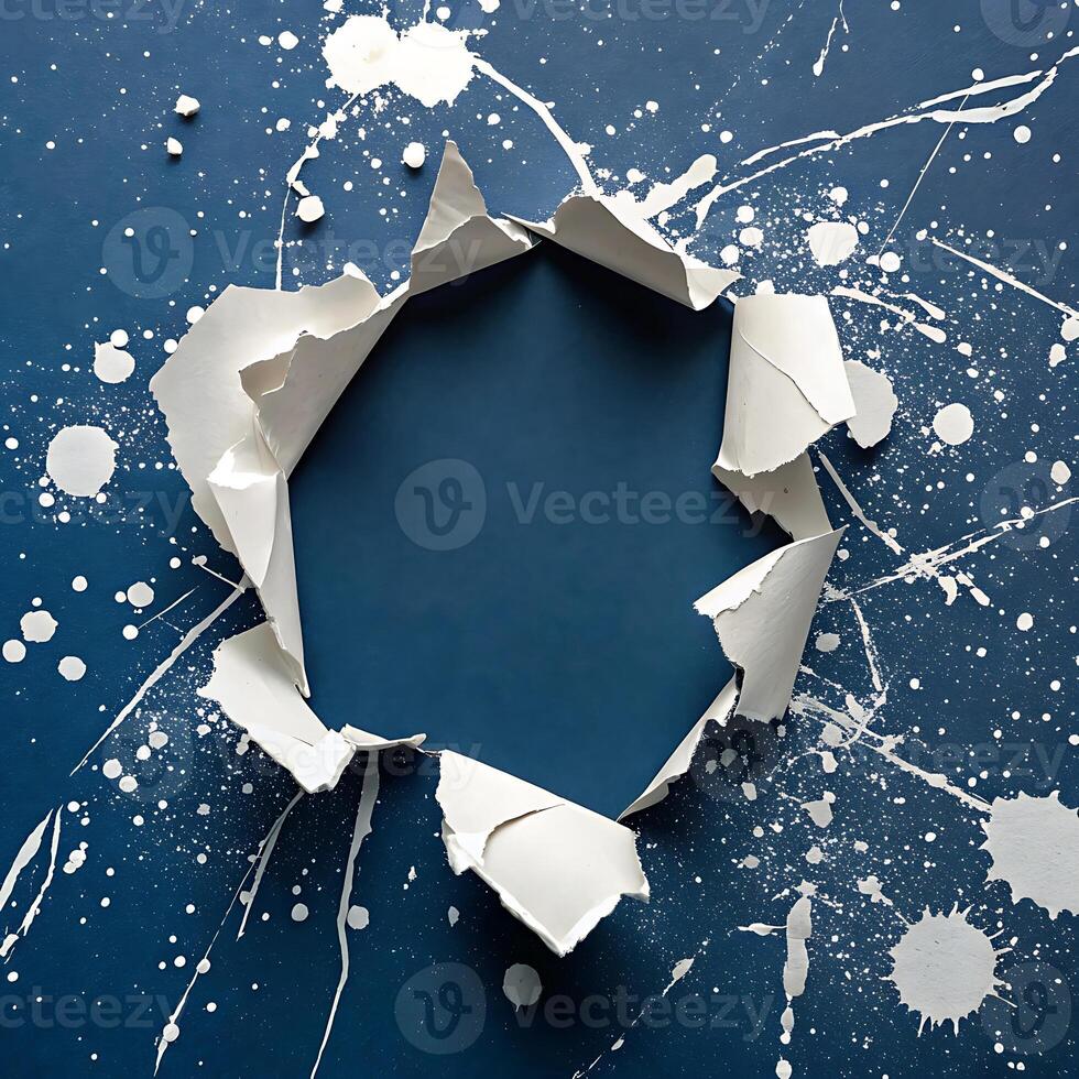 Abstract blue paper with torn hole and splatter white paint design photo