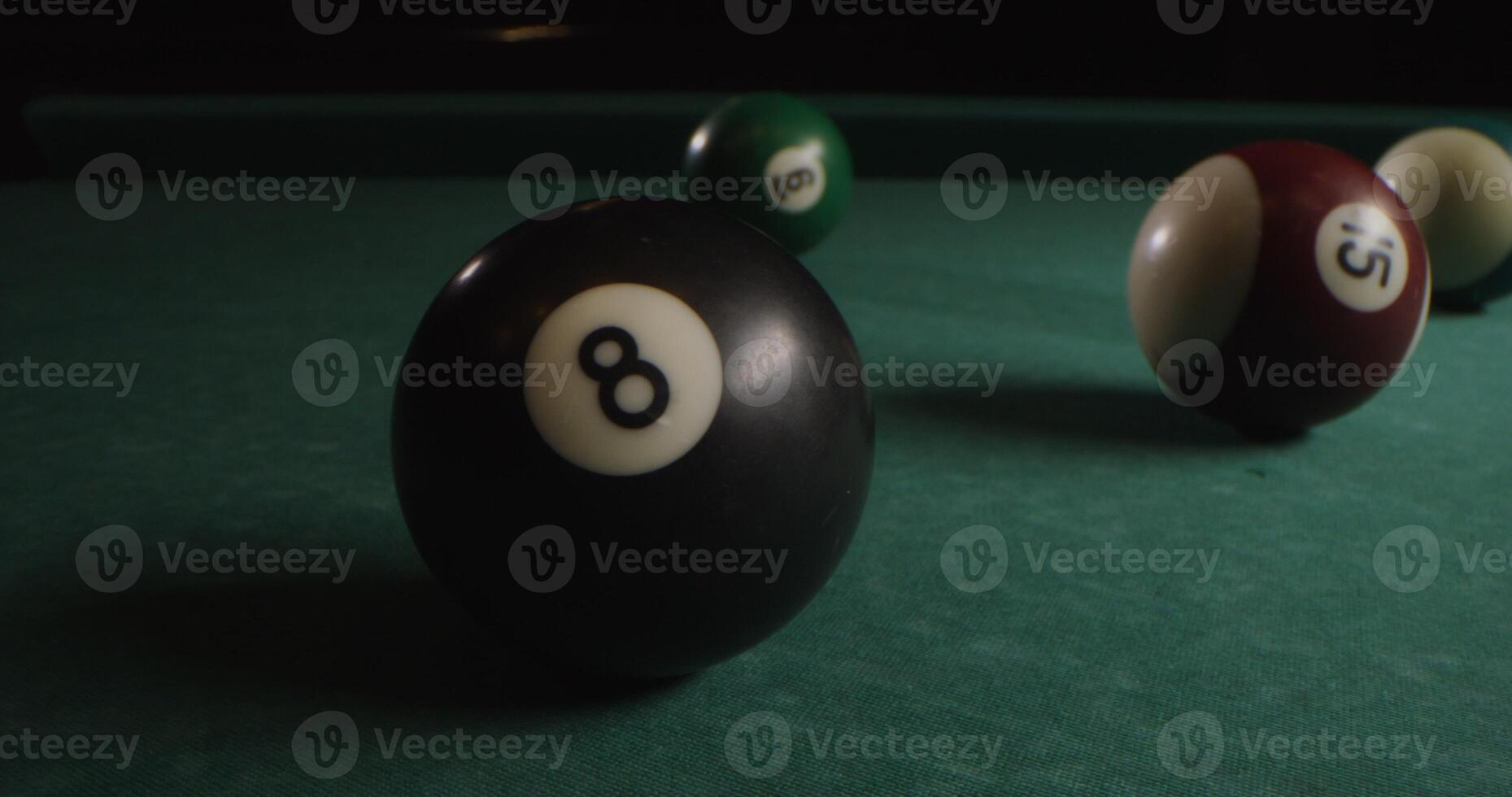 Multi-colored billiard balls in a chaotic manner lie on the billiard table, slow shooting without moving objects, without people in the frame photo