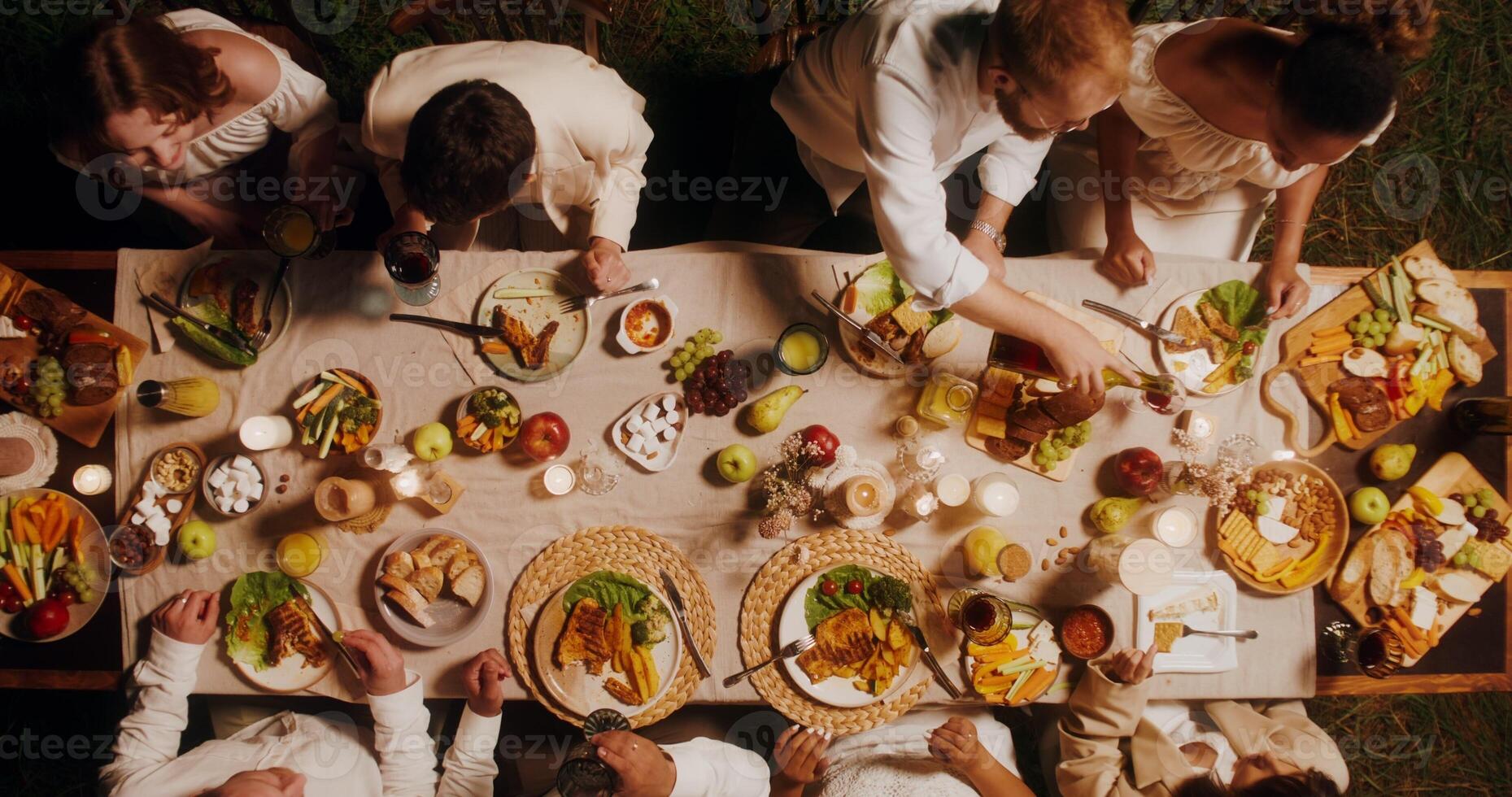 Top view of a beautifully laid festive table. Guests eat and talk while sitting at the table outdoor photo