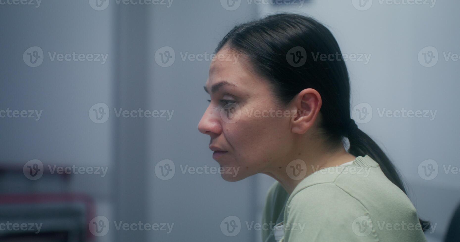A woman is worried sitting in the hospital corridor and waiting for the result of her loved one's operation - corridor photo