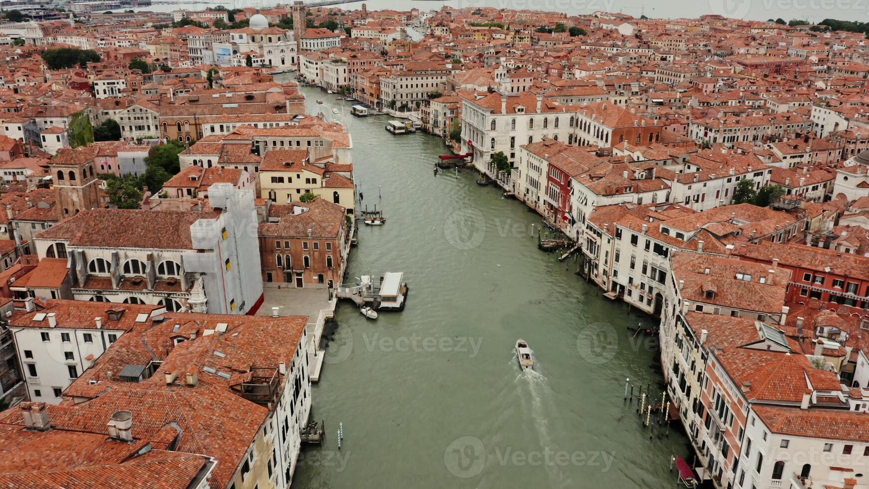 Top view of the Grand Canal with empty gondolas tied to the pier. Traditional houses on both sides of the canal, drone footage on a sunny day. Venice, Italy - houses photo