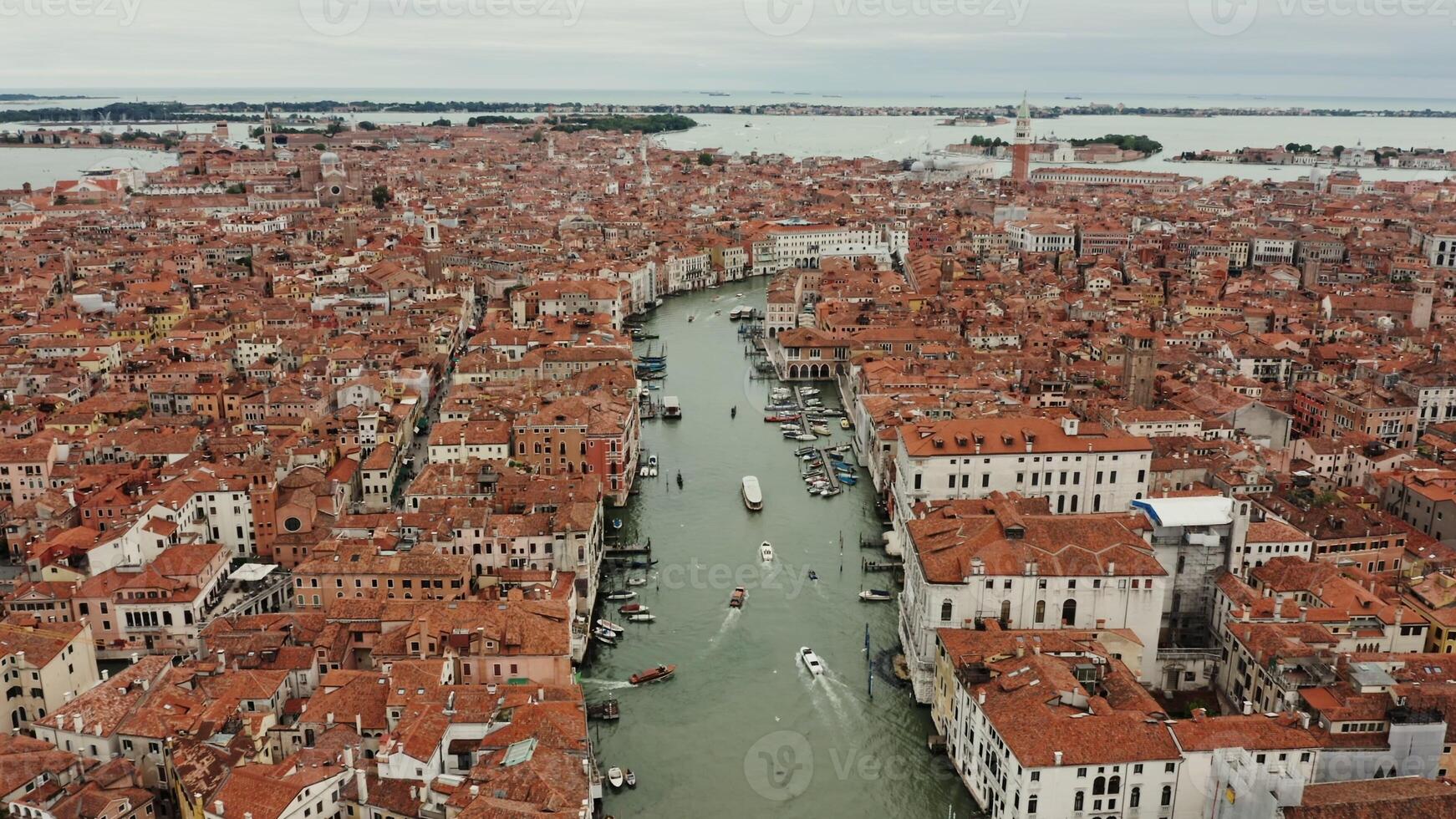 View from above of the Grand Canal with ships sailing along it and old traditional houses with orange roofs in the historic center of Venice. Italy. Drone - houses photo