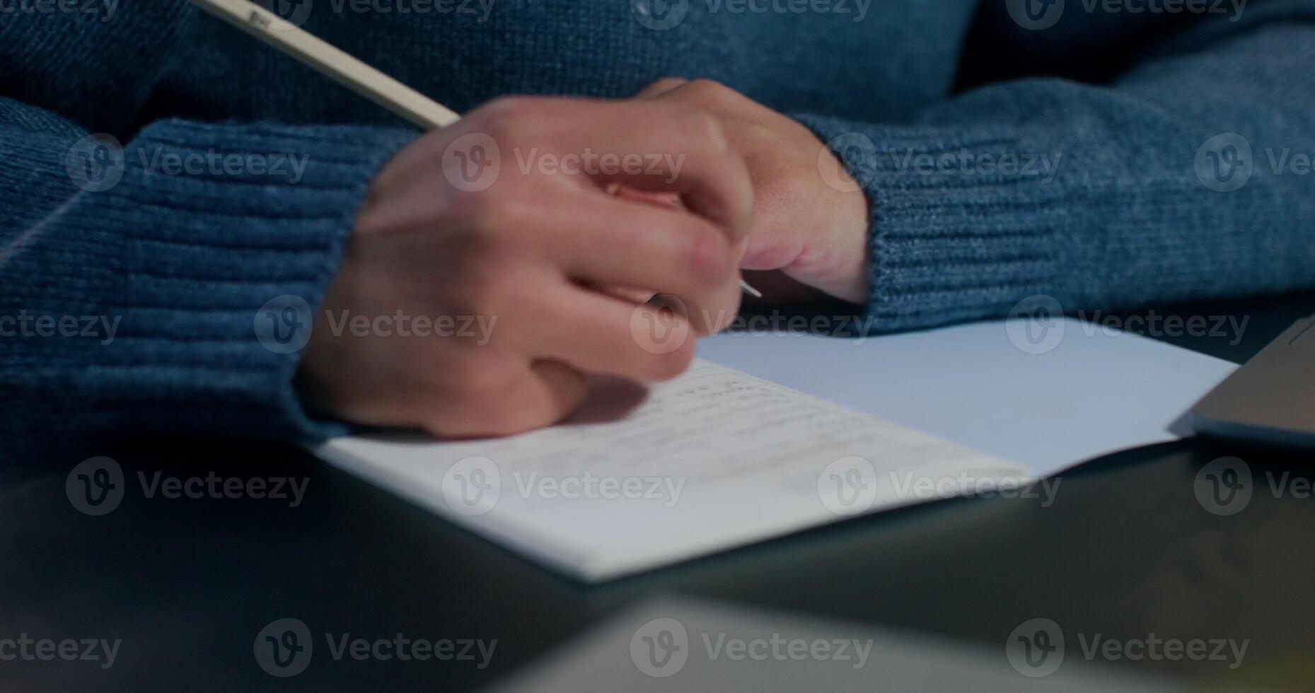 A woman is typing on a laptop sitting at her desk, working in the office, close-up of her hands, an unrecognizable person - sitting photo
