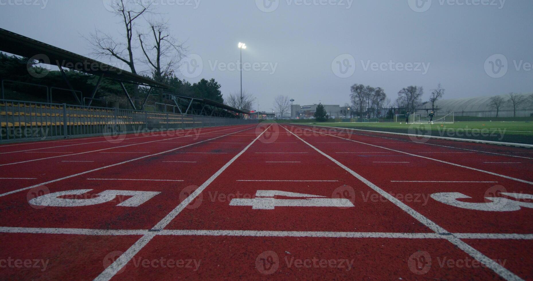 Running tracks in the stadium, close-up of the lined and numbered outdoor stadium flooring photo